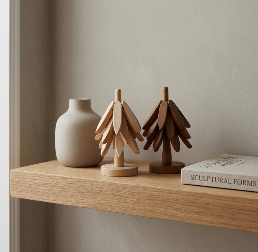 The Grove in Morning and Evening together on a wood shelf with a ceramic vase.
