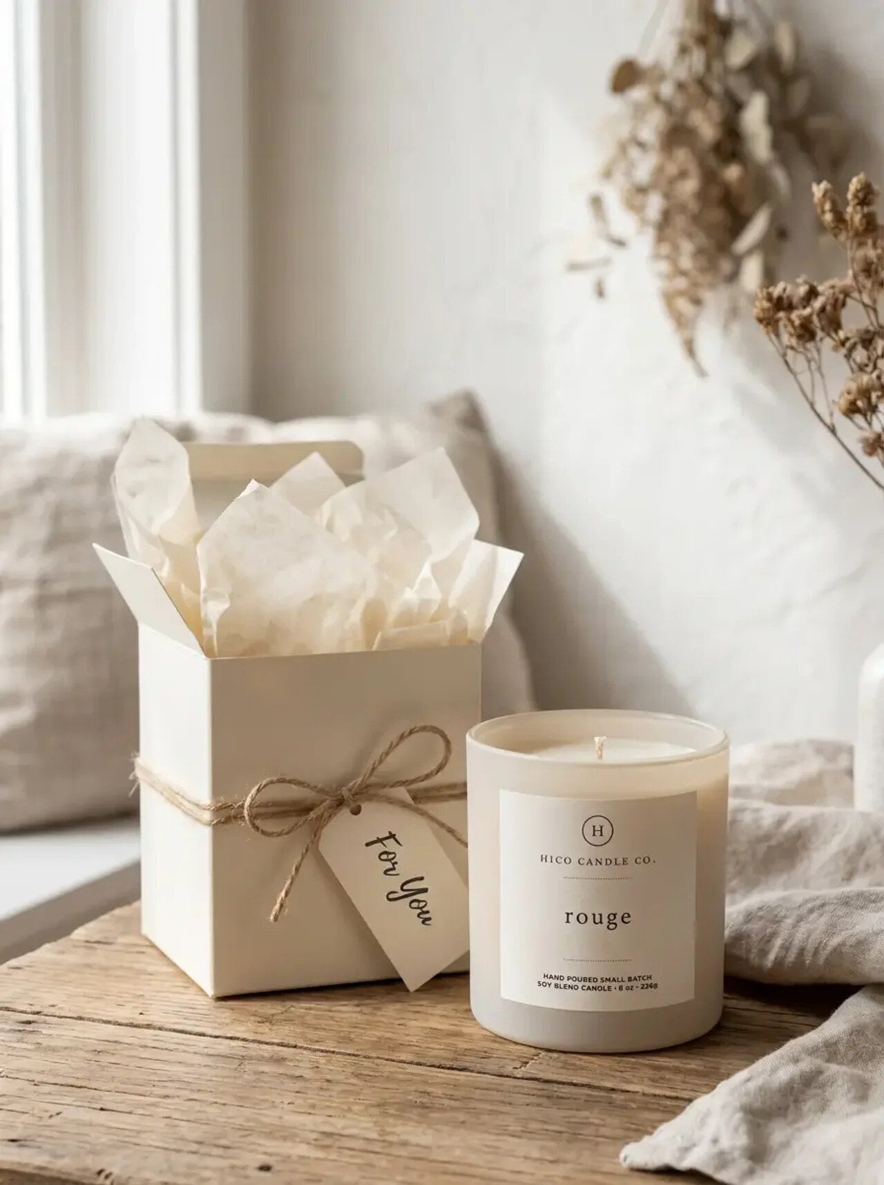 Hico Rouge candle beside its open gift box and tissue.